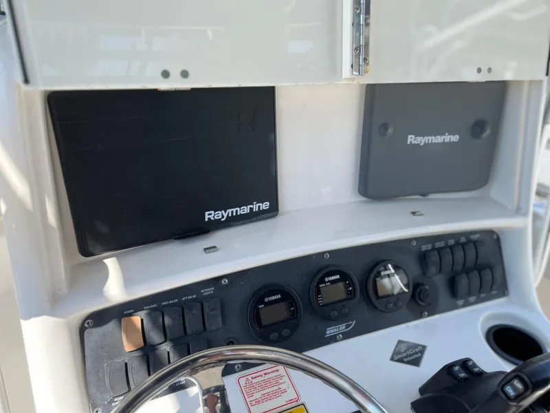 Slide: The Image of Boston Whaler 240 Outrage 2004 dashboard with Raymarine electronics and controls. - 7
