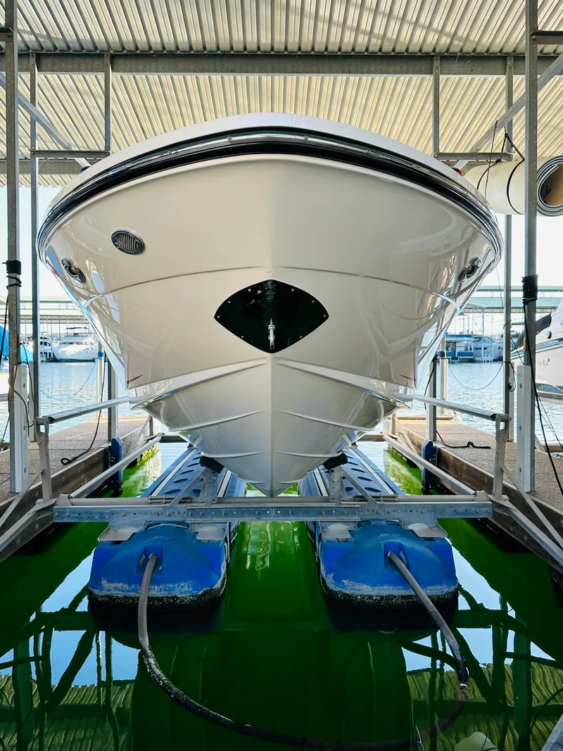Slide: The Image of 2015 Sea Ray 250 SLX boat docked in marina, front view. - 13