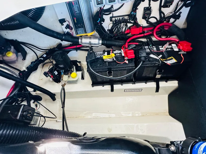 Slide: The Image of 2015 Sea Ray 250 SLX boat battery compartment with wiring and components. - 20