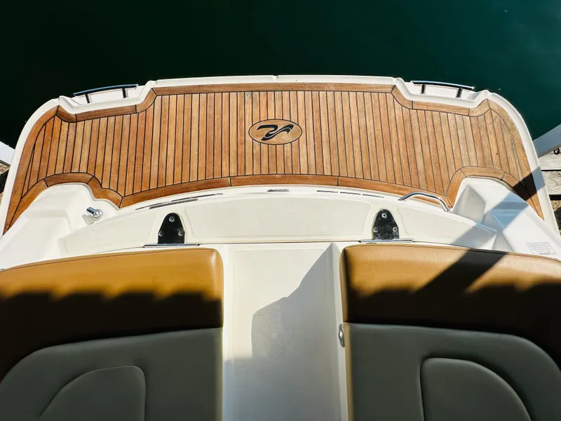 Slide: The Image of 2015 Sea Ray 250 SLX boat deck with teak flooring and seating. - 23