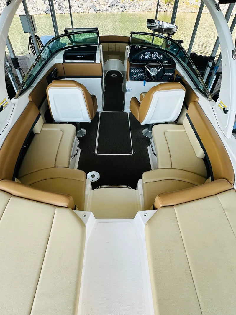 Slide: The Image of 2015 Sea Ray 250 SLX boat interior with tan and white seating, sleek design. - 24
