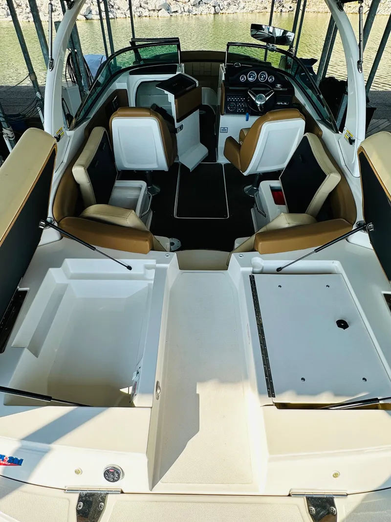 Slide: The Image of 2015 Sea Ray 250 SLX boat interior with tan and white seating, sleek design. - 27