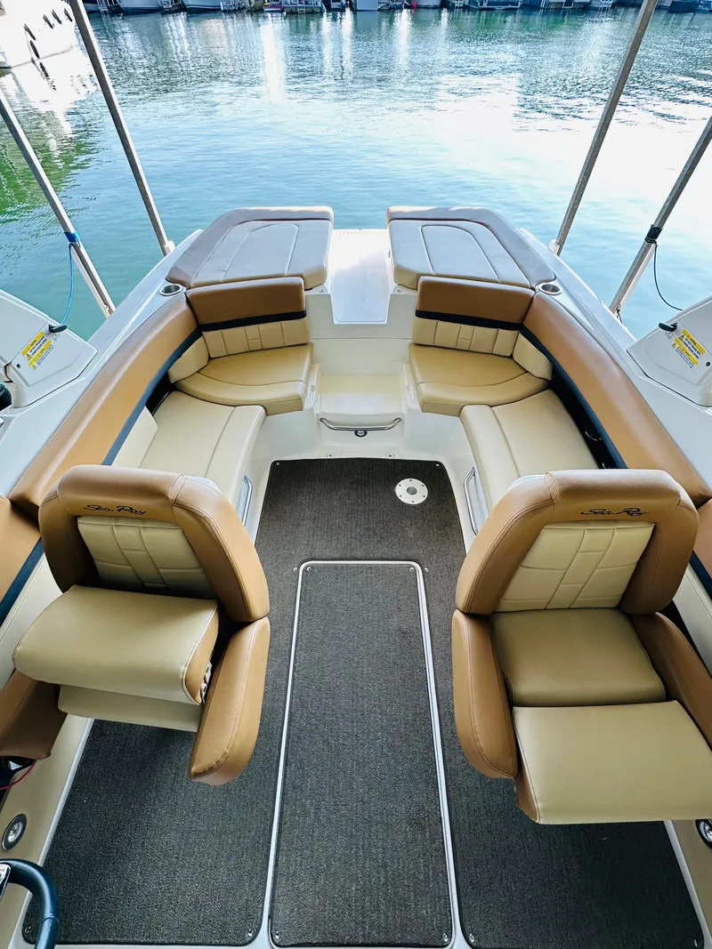 Slide: The Image of 2015 Sea Ray 250 SLX boat interior with tan leather seating and lake view. - 28