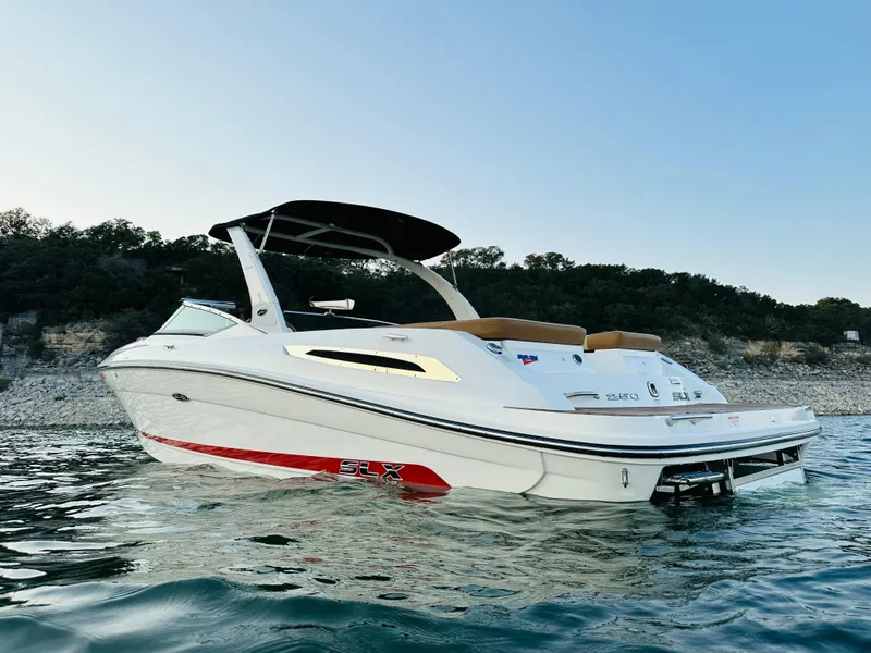 Slide: The Image of 2015 Sea Ray 250 SLX boat on calm water with scenic background. - 3