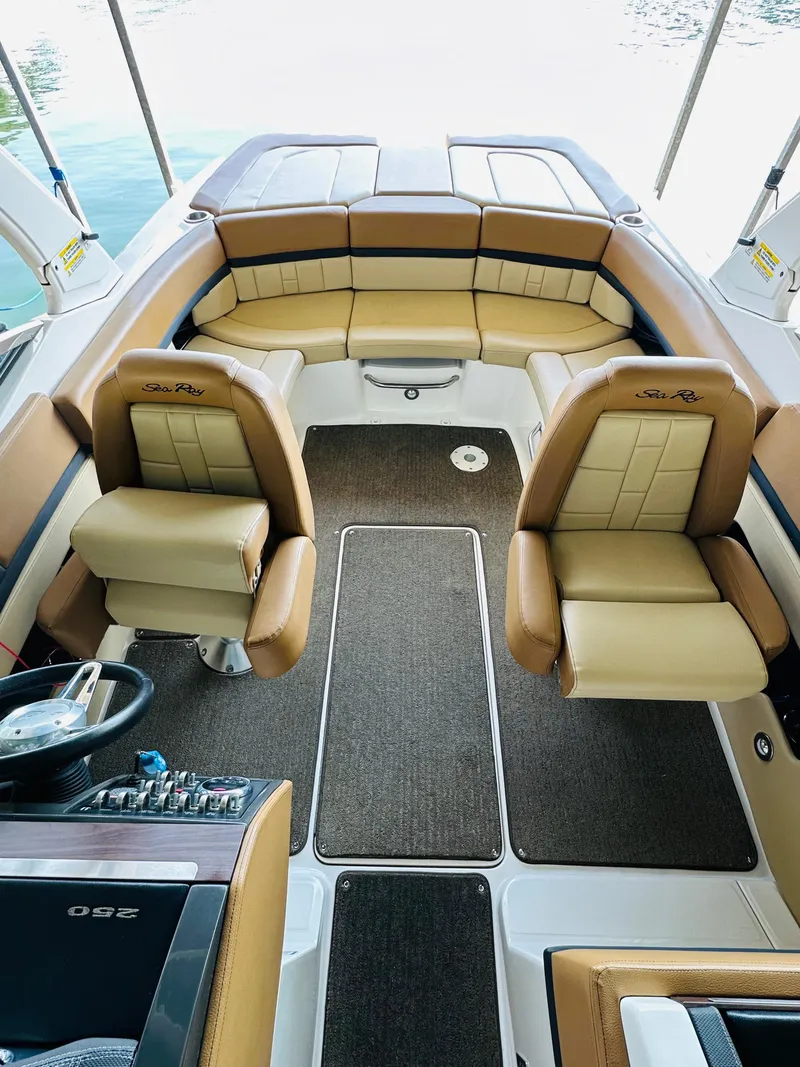 Slide: The Image of Interior of 2015 Sea Ray 250 SLX boat with tan seating and modern dashboard. - 30
