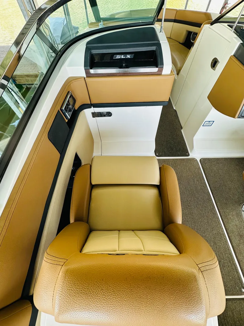 Slide: The Image of 2015 Sea Ray 250 SLX boat interior with tan leather seating and modern dashboard. - 31