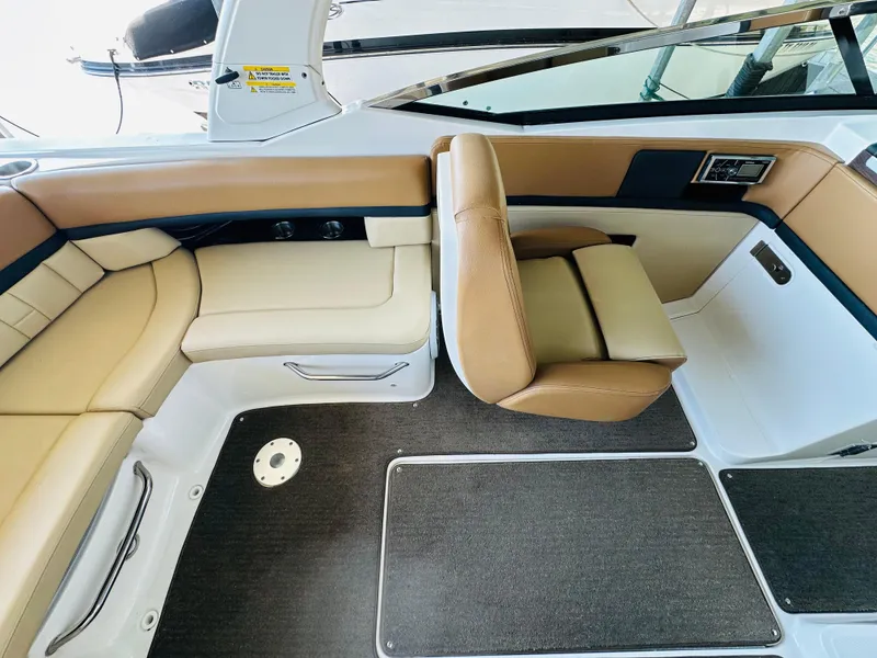 Slide: The Image of 2015 Sea Ray 250 SLX boat interior with tan leather seating and modern design. - 33