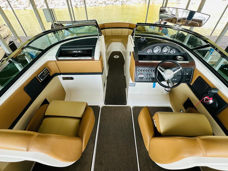 Slide: The Image of 2015 Sea Ray 250 SLX boat interior with tan seats and modern dashboard. - 36