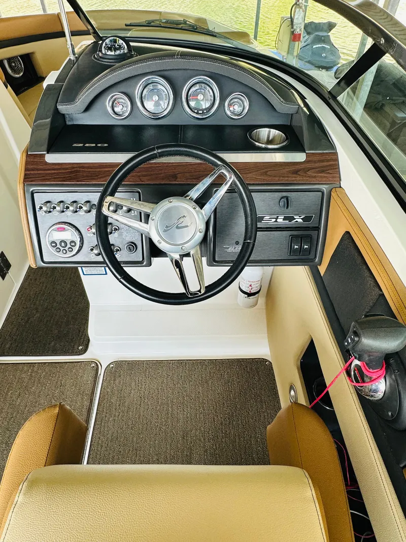 Slide: The Image of 2015 Sea Ray 250 SLX boat dashboard with steering wheel and instrument panel. - 38