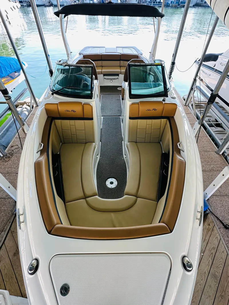 Slide: The Image of 2015 Sea Ray 250 SLX boat with tan seating and sleek design in marina. - 39