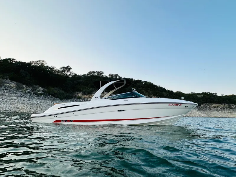 Slide: The Image of 2015 Sea Ray 250 SLX boat on calm water, scenic background. - 4