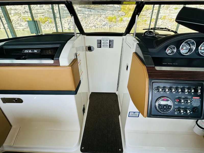 Slide: The Image of Interior view of 2015 Sea Ray 250 SLX boat cockpit with control panel and seating. - 42