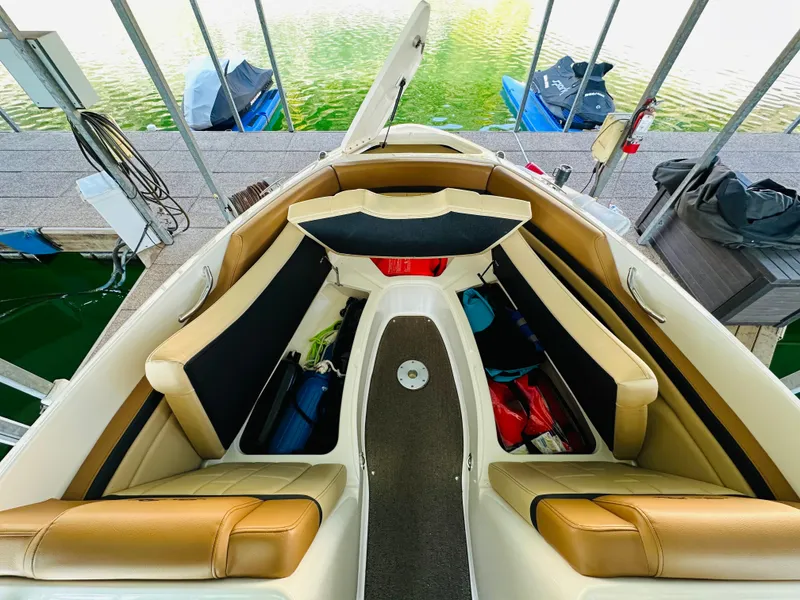 Slide: The Image of Interior view of 2015 Sea Ray 250 SLX boat with tan seating and storage compartments. - 43