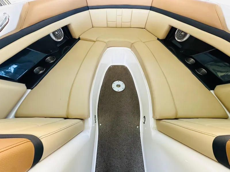 Slide: The Image of 2015 Sea Ray 250 SLX boat interior with tan leather seating and cup holders. - 45