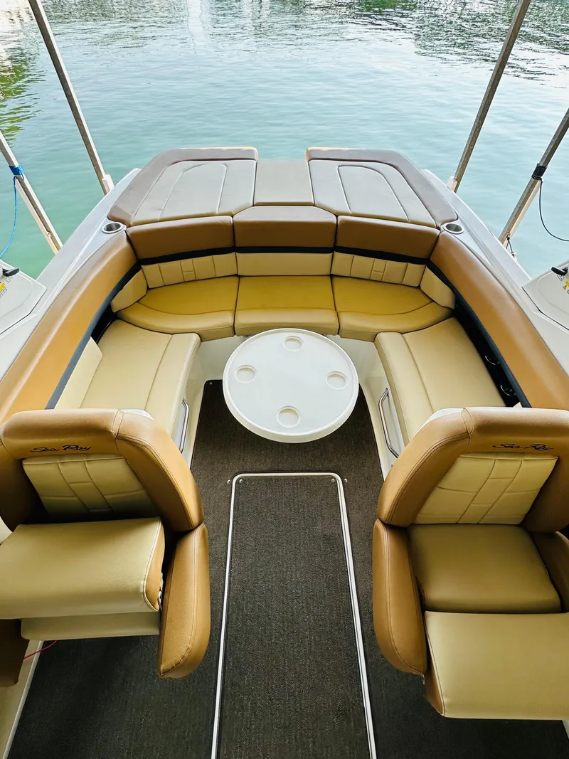 Slide: The Image of Luxurious 2015 Sea Ray 250 SLX boat interior with tan leather seating and round table. - 46
