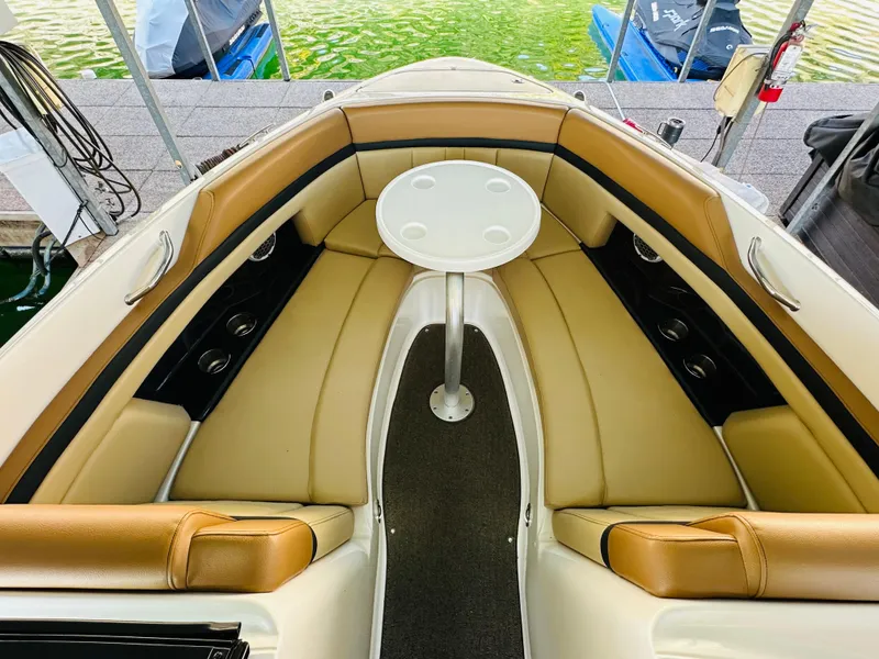 Slide: The Image of Interior of 2015 Sea Ray 250 SLX boat with tan seating and round table. - 47