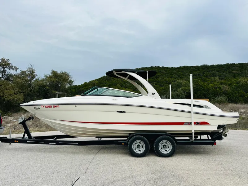 Slide: The Image of 2015 Sea Ray 250 SLX boat on trailer, parked outdoors. - 49