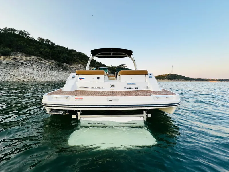 Slide: The Image of 2015 Sea Ray 250 SLX boat on calm water, rear view. - 6
