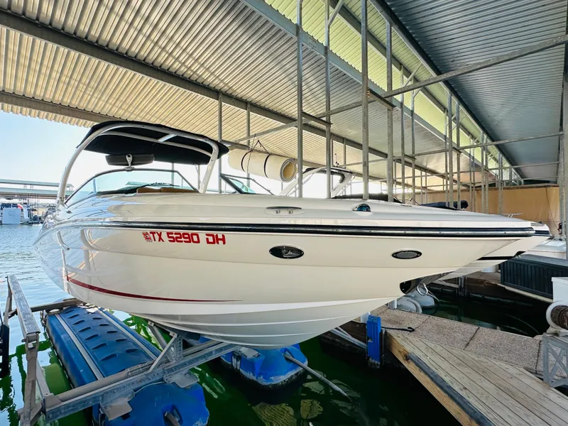 Slide: The Image of 2015 Sea Ray 250 SLX boat docked under a metal canopy. - 8