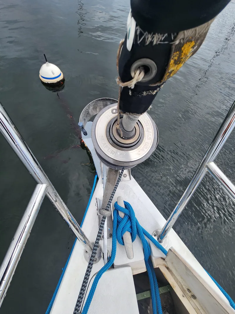 Slide: The Image of Bow of 1987 Catalina 36 sailboat with mooring buoy and ropes. - 10