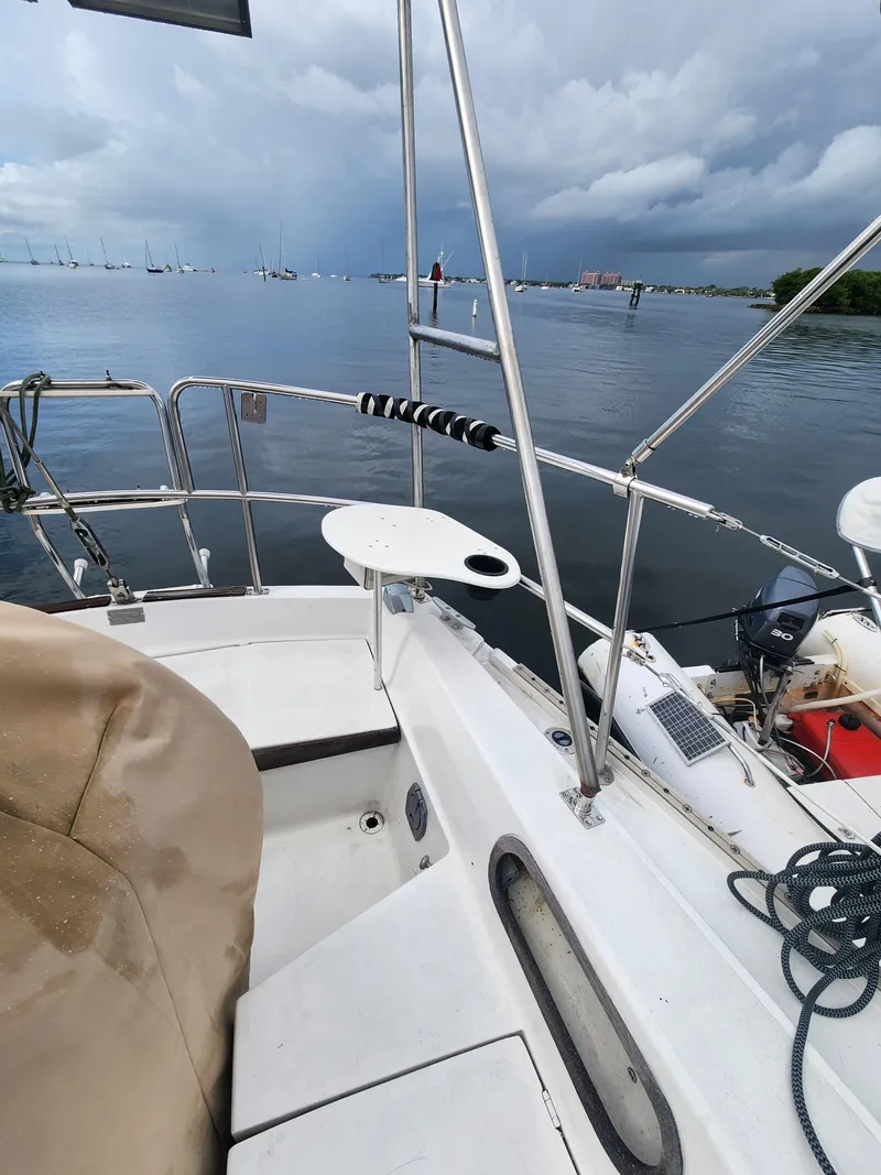 Slide: The Image of 1987 Catalina 36 sailboat deck with ocean view and cloudy sky. - 14