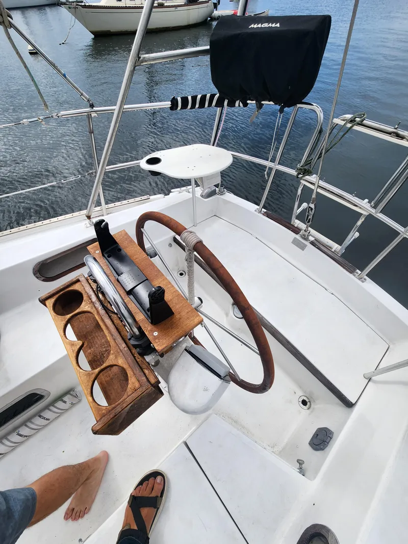 Slide: The Image of Cockpit of a 1987 Catalina 36 sailboat with wooden steering wheel and cup holders. - 15