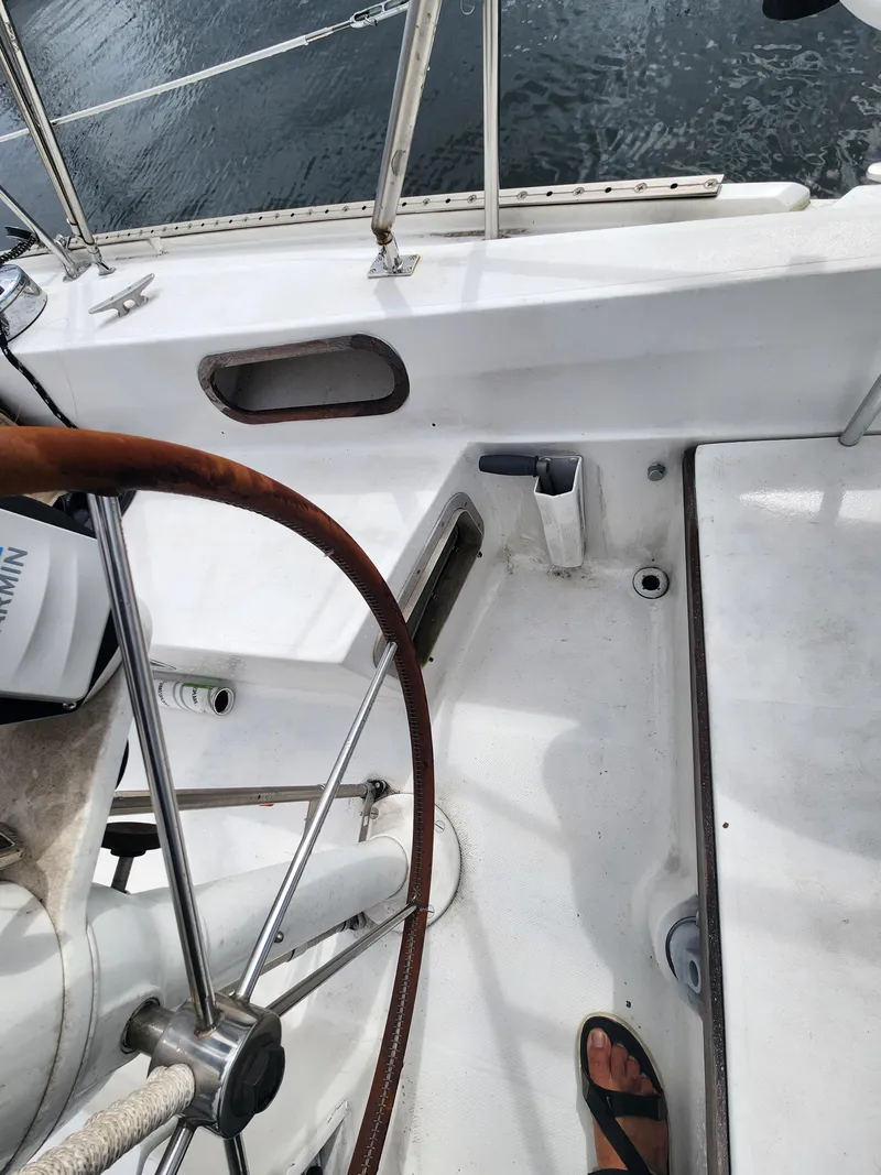Slide: The Image of Cockpit of 1987 Catalina 36 sailboat with steering wheel and deck details. - 17