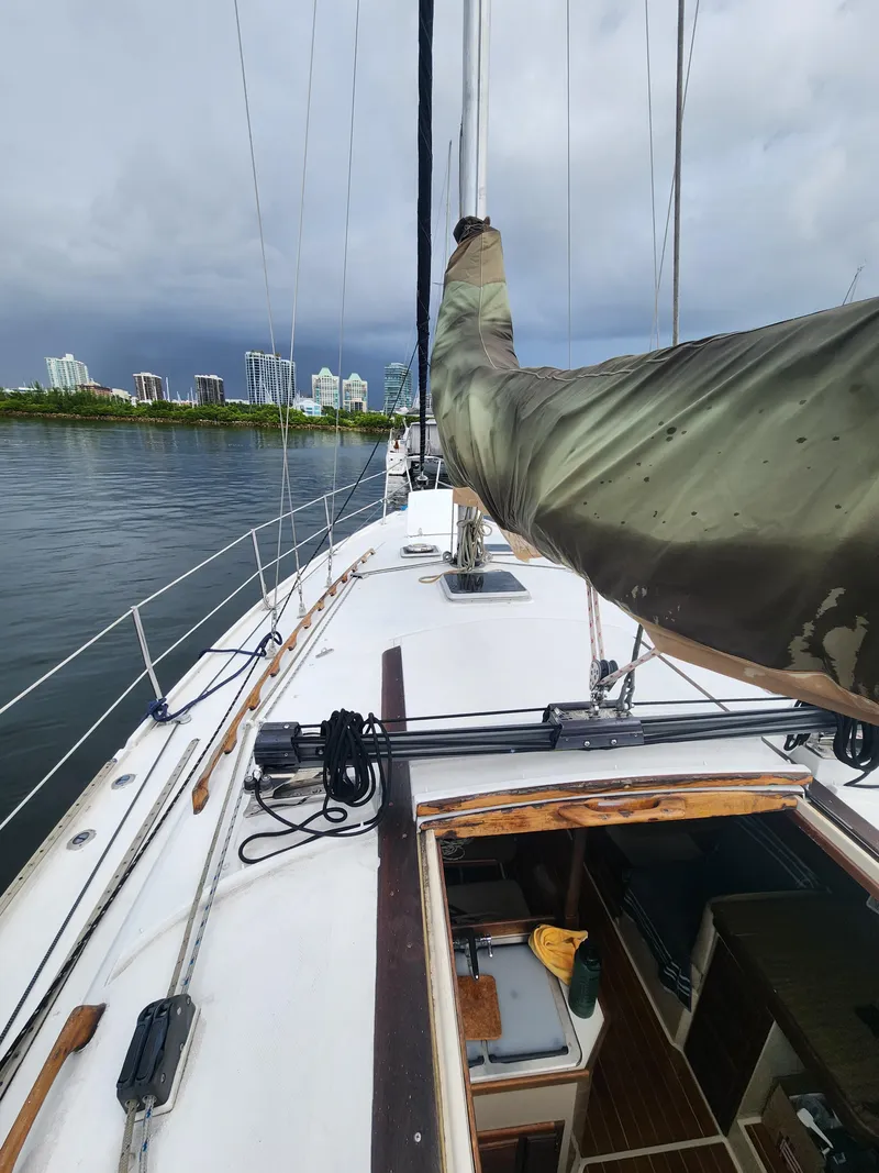 Slide: The Image of 1987 Catalina 36 sailboat deck with city skyline in the background. - 2