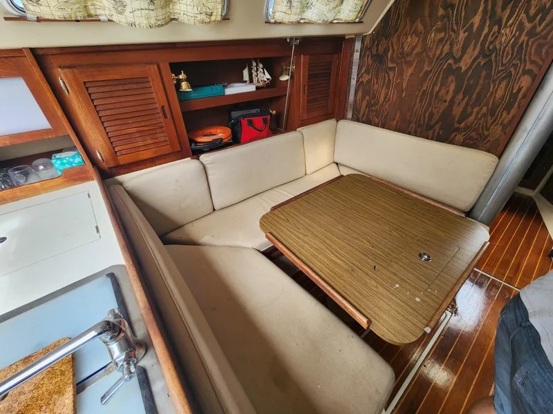 Slide: The Image of Interior of 1987 Catalina 36 sailboat with cozy seating and wooden table. - 25