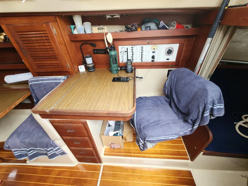 Slide: The Image of Interior of a 1987 Catalina 36 sailboat with navigation station and wooden cabinetry. - 26