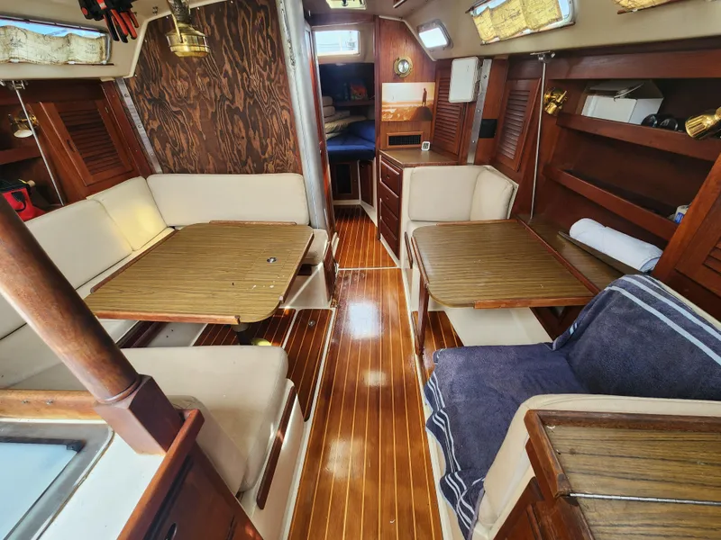 Slide: The Image of Interior of a 1987 Catalina 36 sailboat with wooden furnishings and cozy seating. - 27