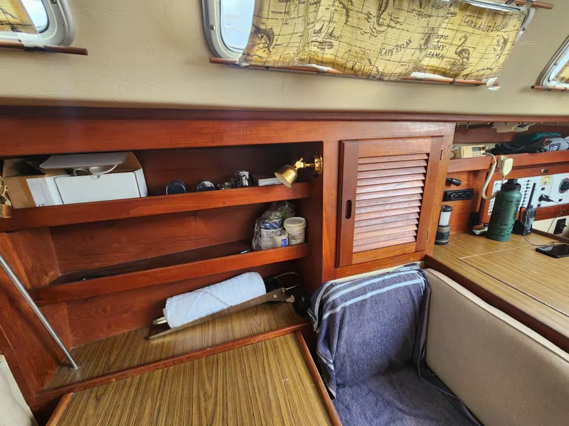 Slide: The Image of 1987 Catalina 36 sailboat interior with wooden shelves and nautical decor. - 30