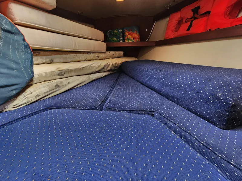 Slide: The Image of Interior cabin of 1987 Catalina 36 sailboat with blue and beige cushions. - 31