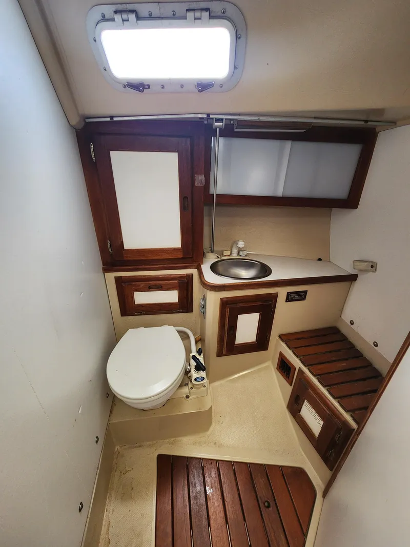 Slide: The Image of Interior of 1987 Catalina 36 sailboat bathroom with wooden accents and compact design. - 32