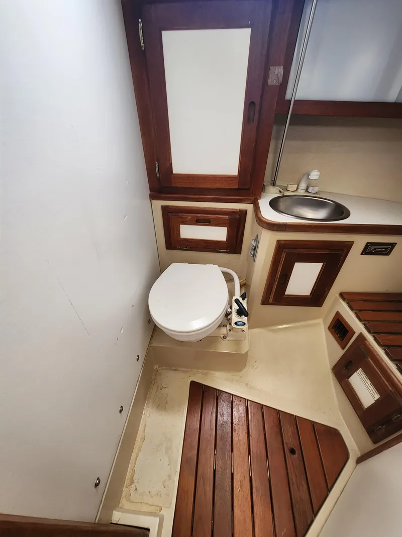 Slide: The Image of 1987 Catalina 36 yacht bathroom with wooden accents and compact design. - 34