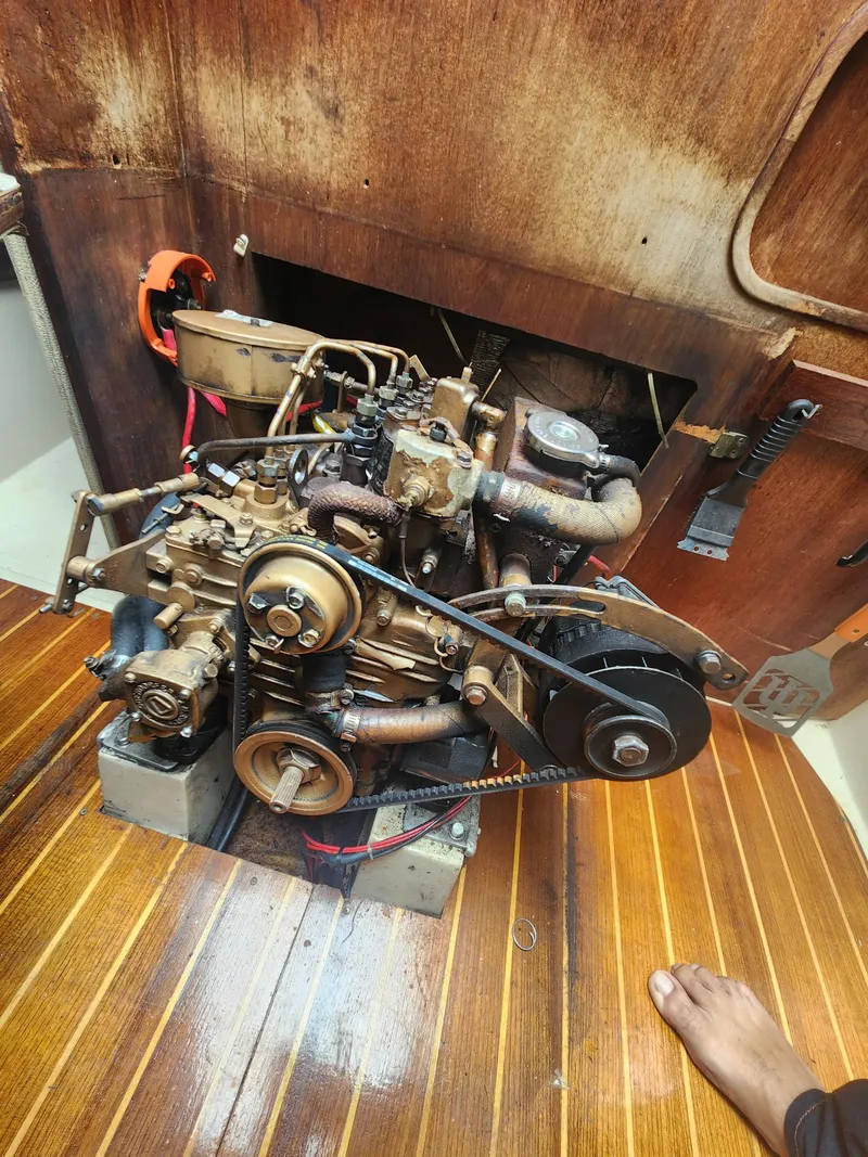 Slide: The Image of 1987 Catalina 36 engine compartment with visible mechanical components and wooden flooring. - 37