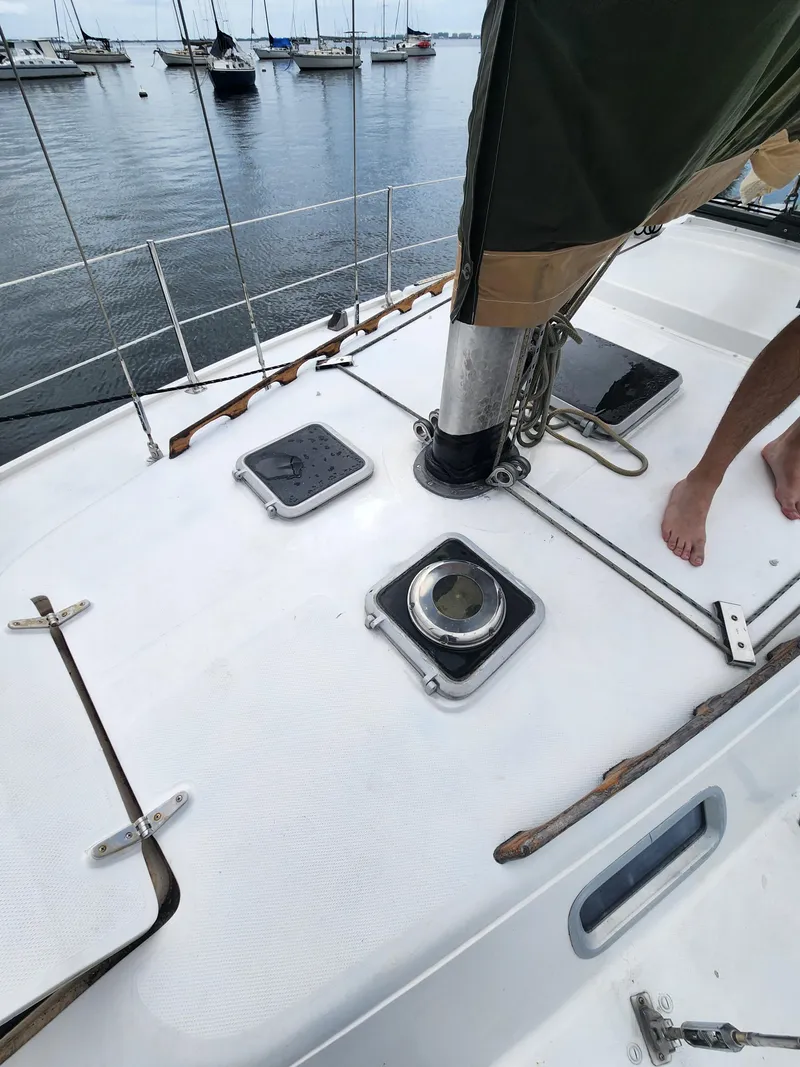 Slide: The Image of 1987 Catalina 36 sailboat deck with hatches, moored in a marina. - 6