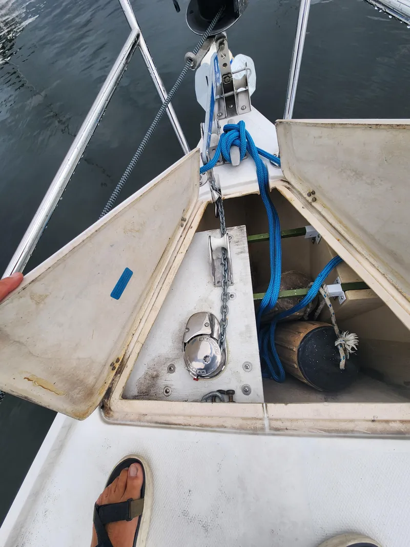 Slide: The Image of Open anchor locker on 1987 Catalina 36 sailboat, showing chain and blue rope. - 7