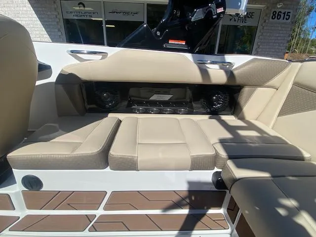 Slide: The Image of 2025 Supreme S220 boat interior with beige seating and modern design. - 11