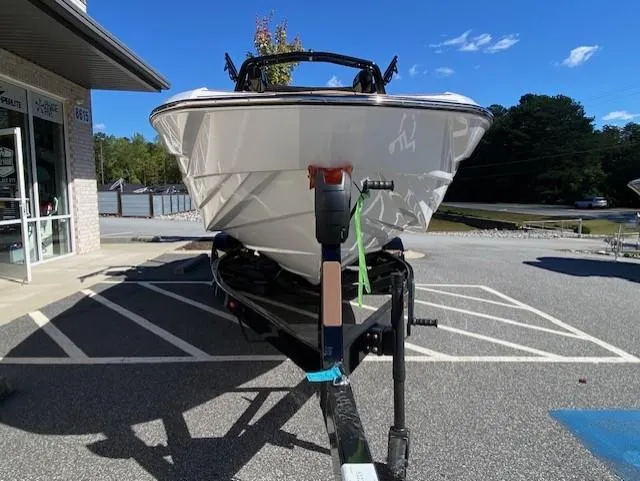 Slide: The Image of 2025 Supreme S220 boat on trailer in parking lot, sunny day. - 4