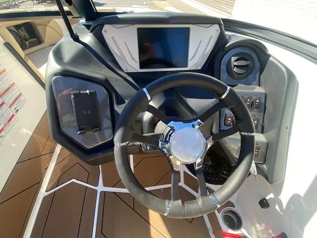 Slide: The Image of 2025 Supreme S220 boat dashboard with steering wheel and digital display. - 5