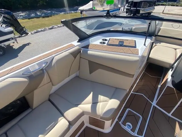 Slide: The Image of Luxurious interior of 2025 Supreme S220 boat with beige seating and modern dashboard. - 6
