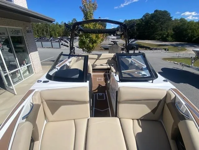 Slide: The Image of 2025 Supreme S220 boat interior with beige seating and open windshield. - 9