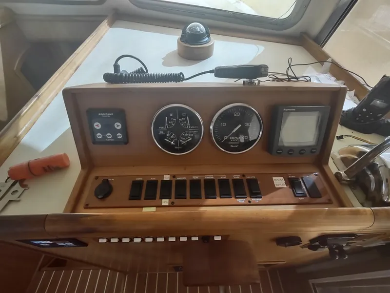 Slide: The Image of Mainship 400 Trawler 2004 helm with gauges, controls, and navigation equipment. - 15