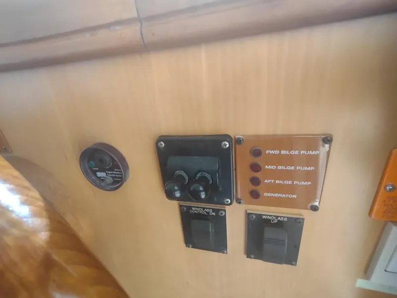 Slide: The Image of Control panel of a 2004 Mainship 400 Trawler with bilge pump switches. - 17