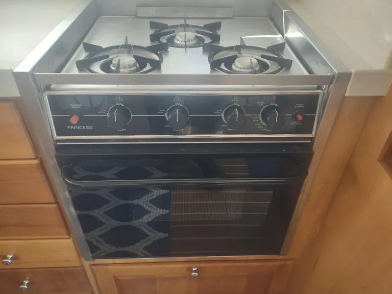 Slide: The Image of Stove and oven in 2004 Mainship 400 Trawler kitchen area. - 23