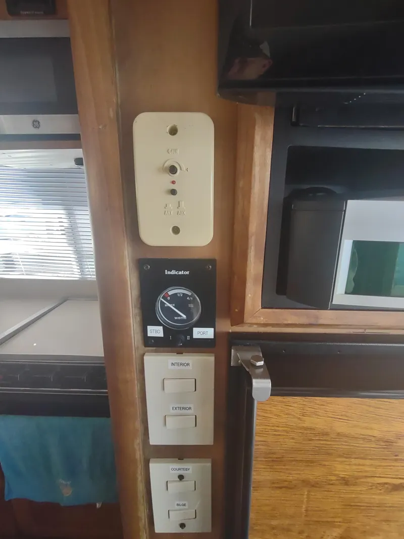 Slide: The Image of 2004 Mainship 400 Trawler interior control panel with microwave and cabinetry. - 35