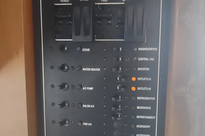 Slide: The Image of Electrical panel of 2004 Mainship 400 Trawler with labeled switches and controls. - 36