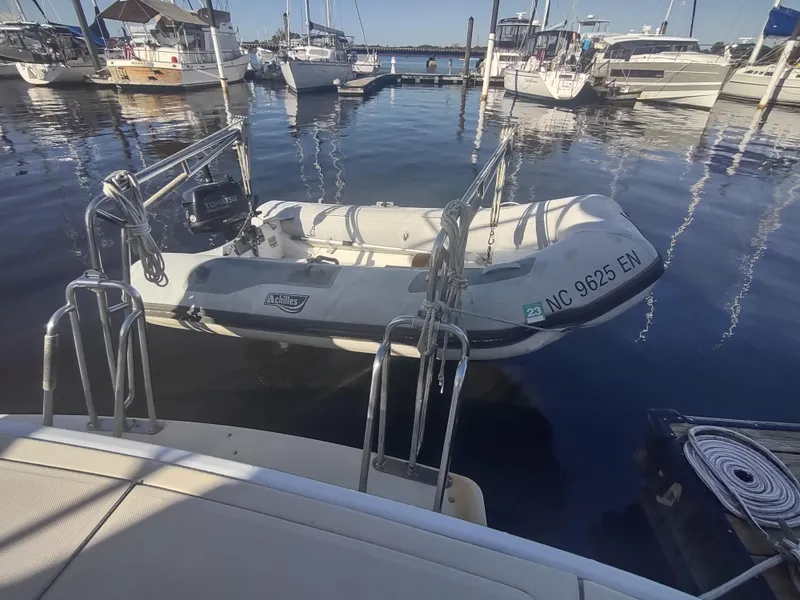 Slide: The Image of 2004 Mainship 400 Trawler docked with inflatable dinghy in marina. - 41