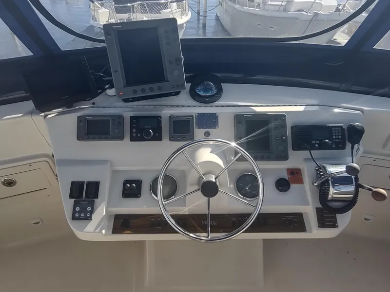 Slide: The Image of 2004 Mainship 400 Trawler helm with navigation equipment and steering wheel. - 45